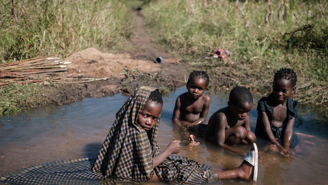 Children play in a stream created by flooded water after the passage of the cyclone Idai, in Mozambique, on March 24, 2019. Scientists say more frequent flooding increases the risk of diseases. 