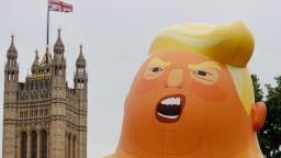A giant balloon depicting US President Donald Trump as an orange baby floats above anti-Trump demonstrators in Parliament Square, London, on the second day of Trump's state visit to the UK.