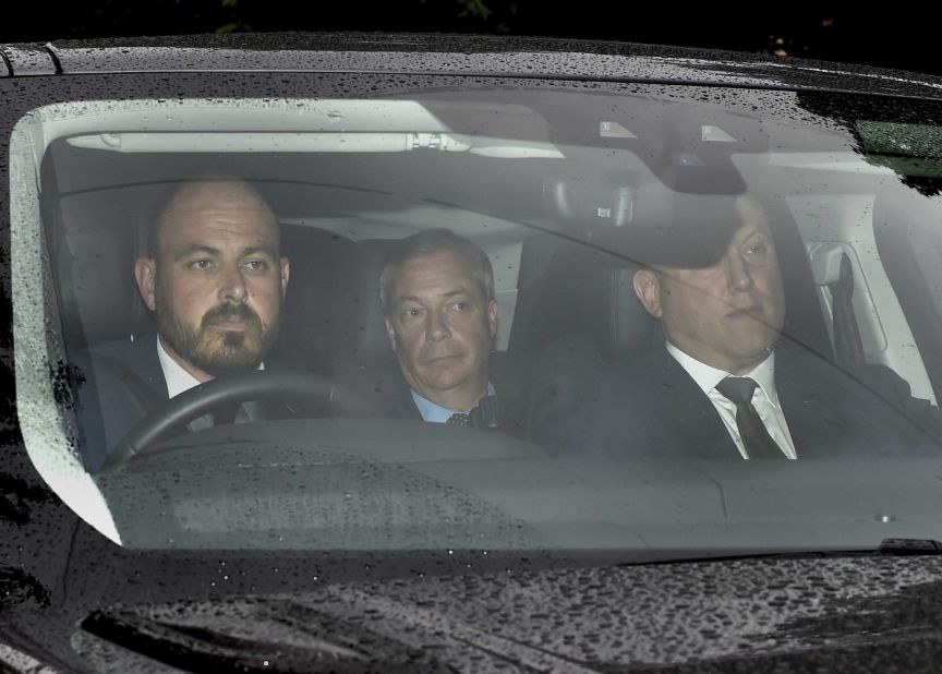 Brexit Party leader Nigel Farage, center, arrives at Winfield House, where the Trumps are staying during their visit.
