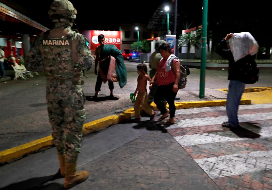A Mexican marine stands by as camping migrant families are evicted from a park in Tapachula on May 29.