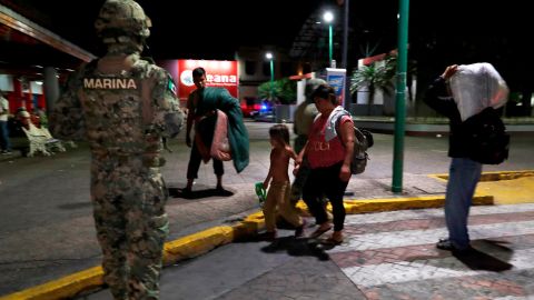 A Mexican marine stands by as camping migrant families are evicted from a park in Tapachula on May 29.