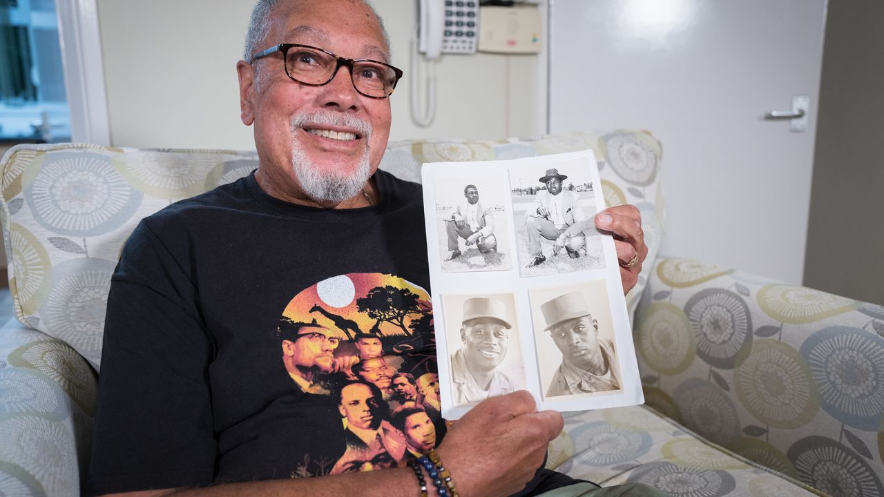 Dave Greene with photographs of his father, who was serving as a photographer in the US Army when he met Dave's mother during World War II. Her family would not let her move to the US.