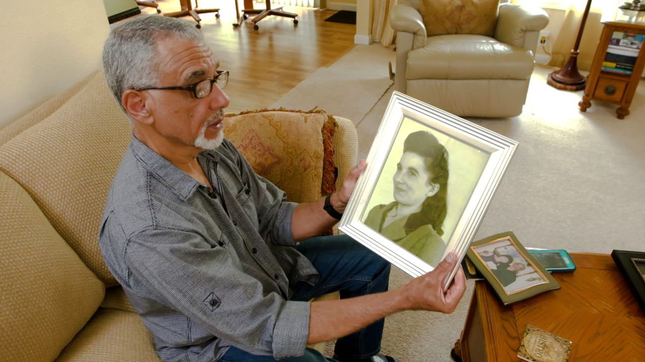 Leon Lomax with a photograph of his mother. He is haunted by the question of why she gave him up.