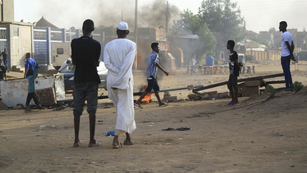 Locals set tyres on fire and block a side street leading to their neighborhood in the Sudanese capital Khartoum to stop military vehicles from driving through the area on June 4, 2019. 