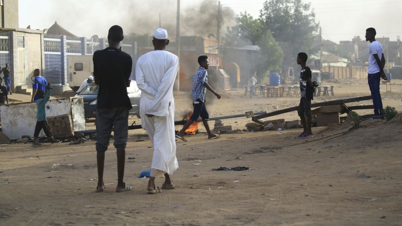 Locals set tyres on fire and block a side street leading to their neighborhood in the Sudanese capital Khartoum to stop military vehicles from driving through the area on June 4, 2019.