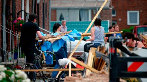 Residents clear away debris Wednesday after a tornado ripped through Bocholt, Germany.