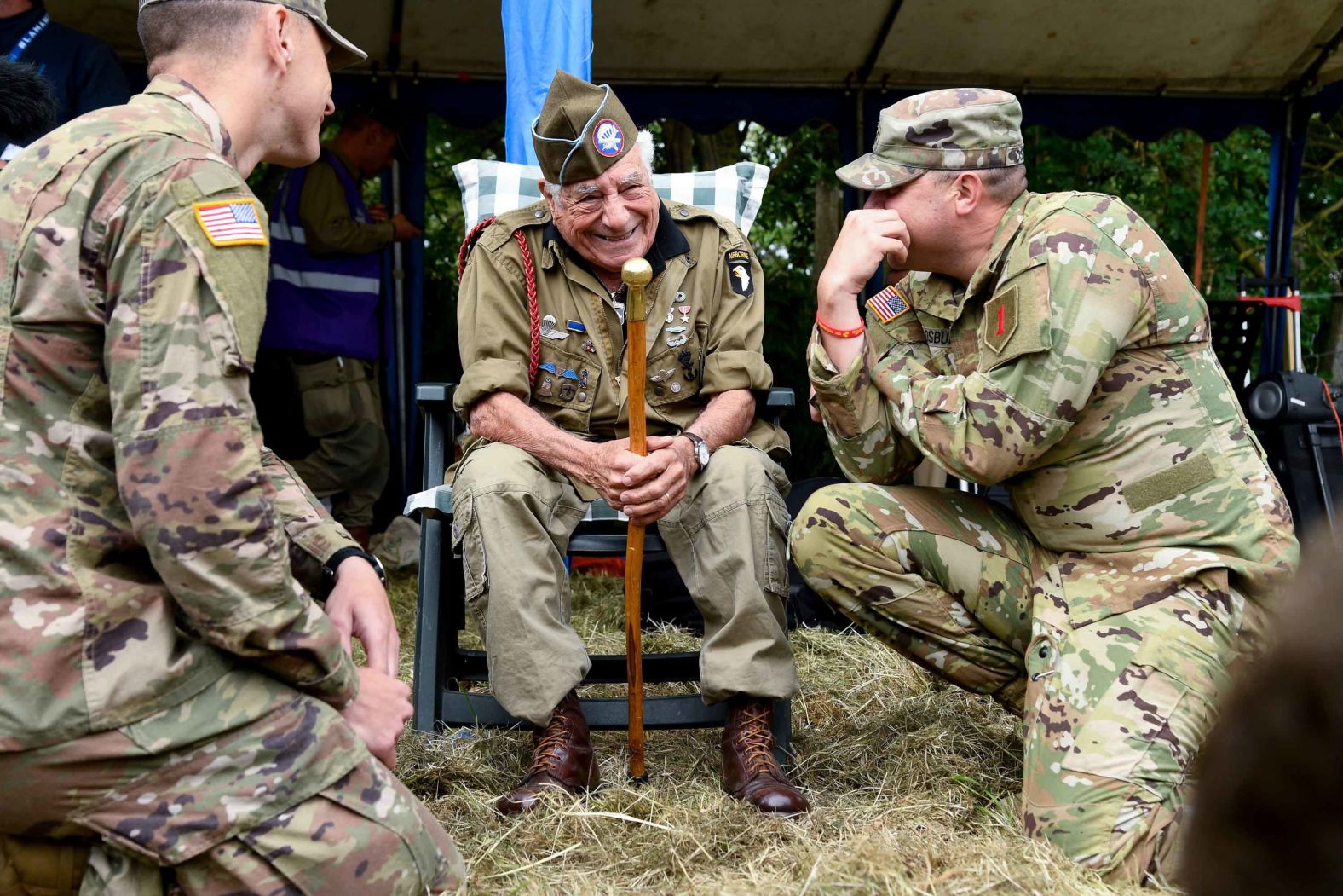 US veteran paratrooper Vincent Speranza speaks with a US soldier as they attend a parachute drop over Carentan on June 5.