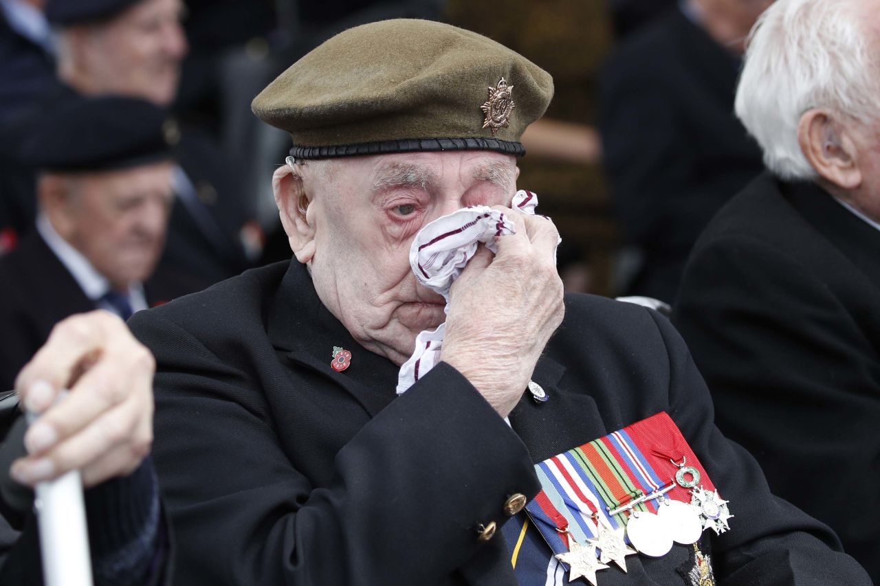 A veteran wipes his eyes during the ceremony in Portsmouth.