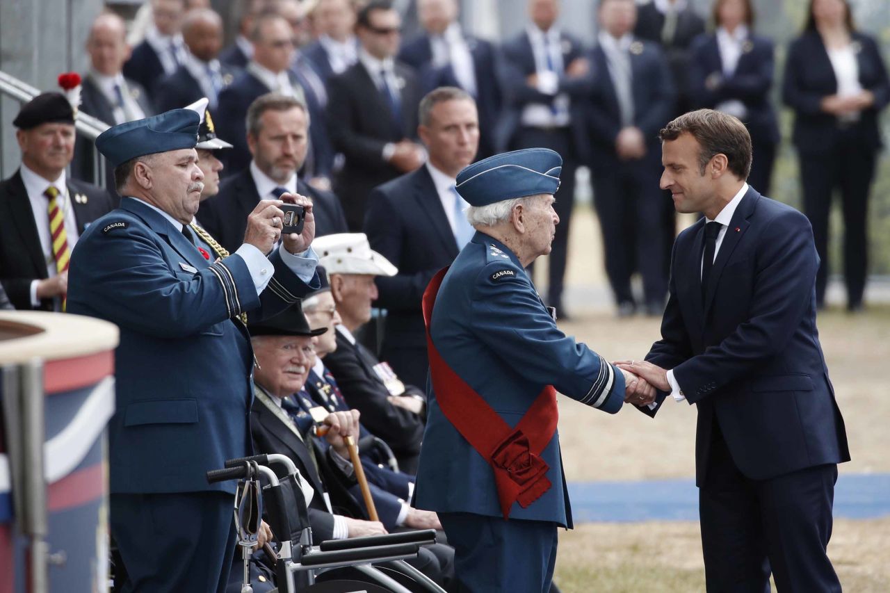 The French President greets a veteran after speaking in Portsmouth on June 5.