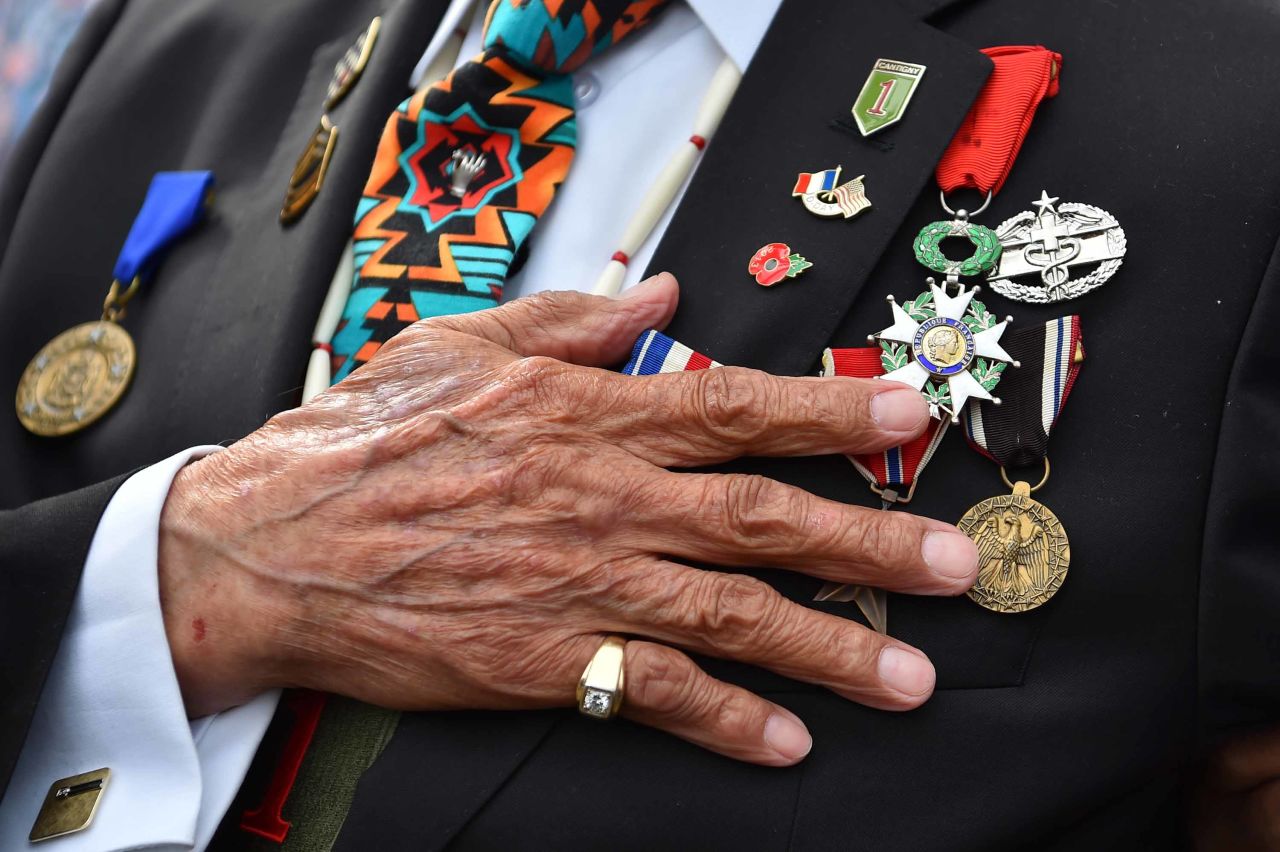 Charles Shay, a World War II veteran and Native American, holds his hand over his heart during the National Anthem at an Omaha Beach ceremony on June 5.