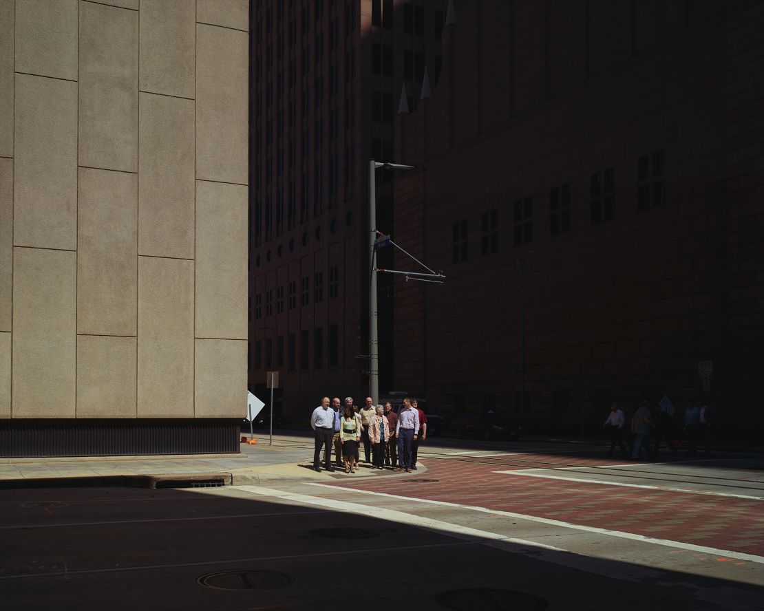 A group of office workers waits before crossing the road at Houston's Louisiana Street.