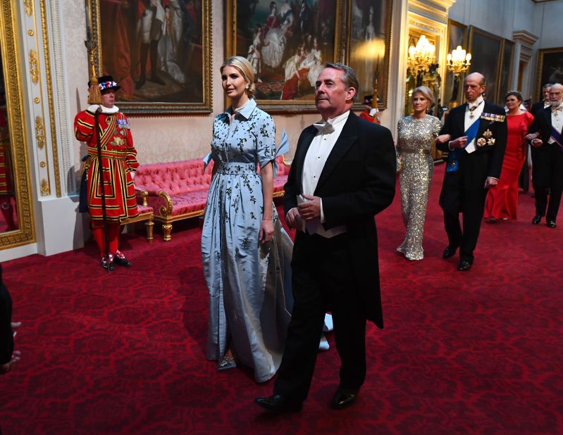 Ivanka Trump, accompanied by Britain's International Trade Secretary Liam Fox, wears a powder blue gown by Venezuelan-American designer Carolina Herrera.