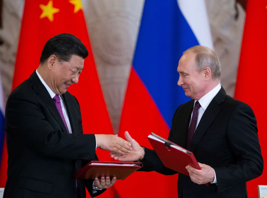 Russian President Vladimir Putin and his Chinese counterpart Xi Jinping exchange documents during a signing ceremony following their talks at the Kremlin in Moscow.