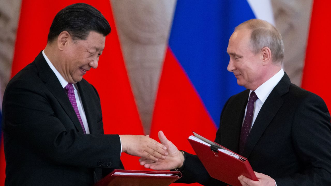 Russian President Vladimir Putin and his Chinese counterpart Xi Jinping exchange documents during a signing ceremony following their talks at the Kremlin in Moscow.