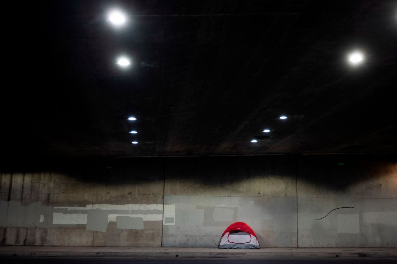 A homeless person's tent is pitched on a sidewalk underneath Interstate 110 on January 3.
