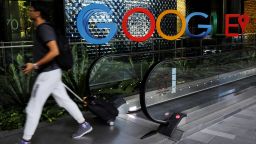 A man passes a Google signage outside its office in Singapore.