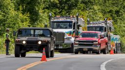 Military police direct traffic along Route 293 near the site where an armored personnel vehicle overturned killing at least one person, Thursday, June 6, 2019, in Cornwall, N.Y. West Point officials say one cadet was killed and over a dozen people were injured when a vehicle they were riding in for summer training overturned. The accident occurred near Camp Natural Bridge, an area where cadet summer training takes place. (AP Photo/Allyse Pulliam)