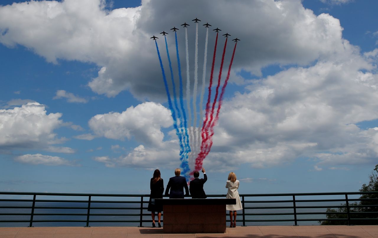 US President Donald Trump, First Lady Melania Trump, French President Emmanuel Macron and his wife, Brigitte Macron, watch flypasts commemorating the 75th anniversary of the D-Day landings on Thursday.