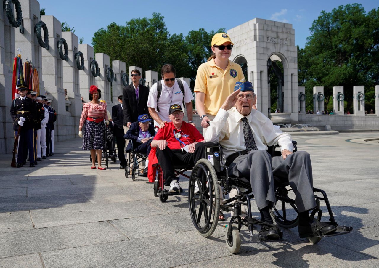 World War II Normandy campaign veterans arrive to take part in a commemoration of the 75th anniversary of the D-Day landings at the World War II Memorial in Washington, DC, on Thursday. 