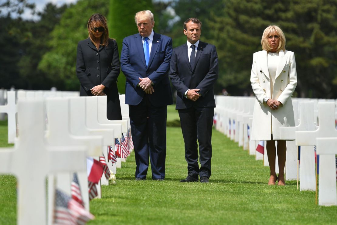 US First lady Melania Trump, US President Donald Trump, French President Emmanuel Macron and his wife, Brigitte Macron, walk through the Normandy American Cemetery and Memorial in Colleville-sur-Mer, France, on June 6, 2019.