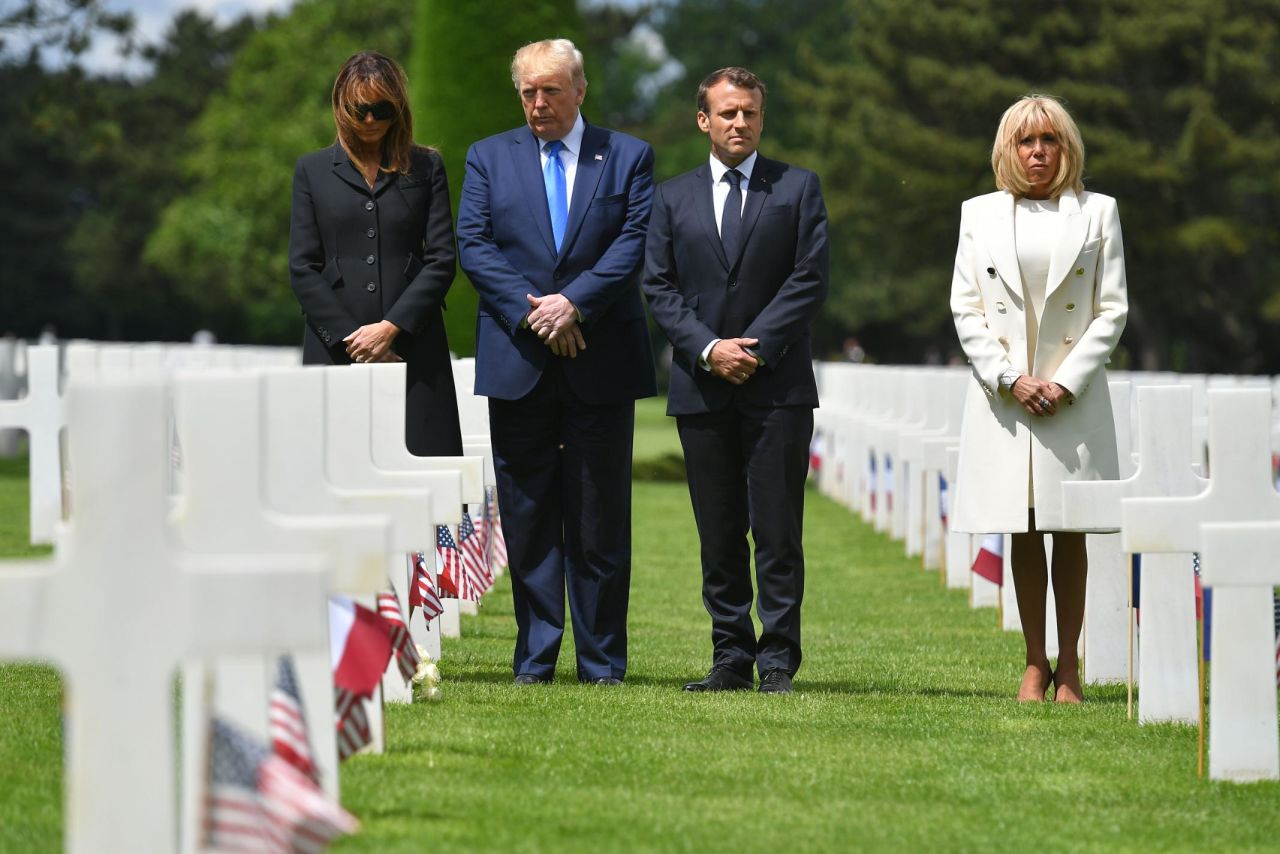 US First Lady Melania Trump, US President Donald Trump, French President Emmanuel Macron and his wife, Brigitte Macron, visit graves after a French-US ceremony at the Normandy American Cemetery and Memorial in Colleville-sur-Mer, France, on Thursday.