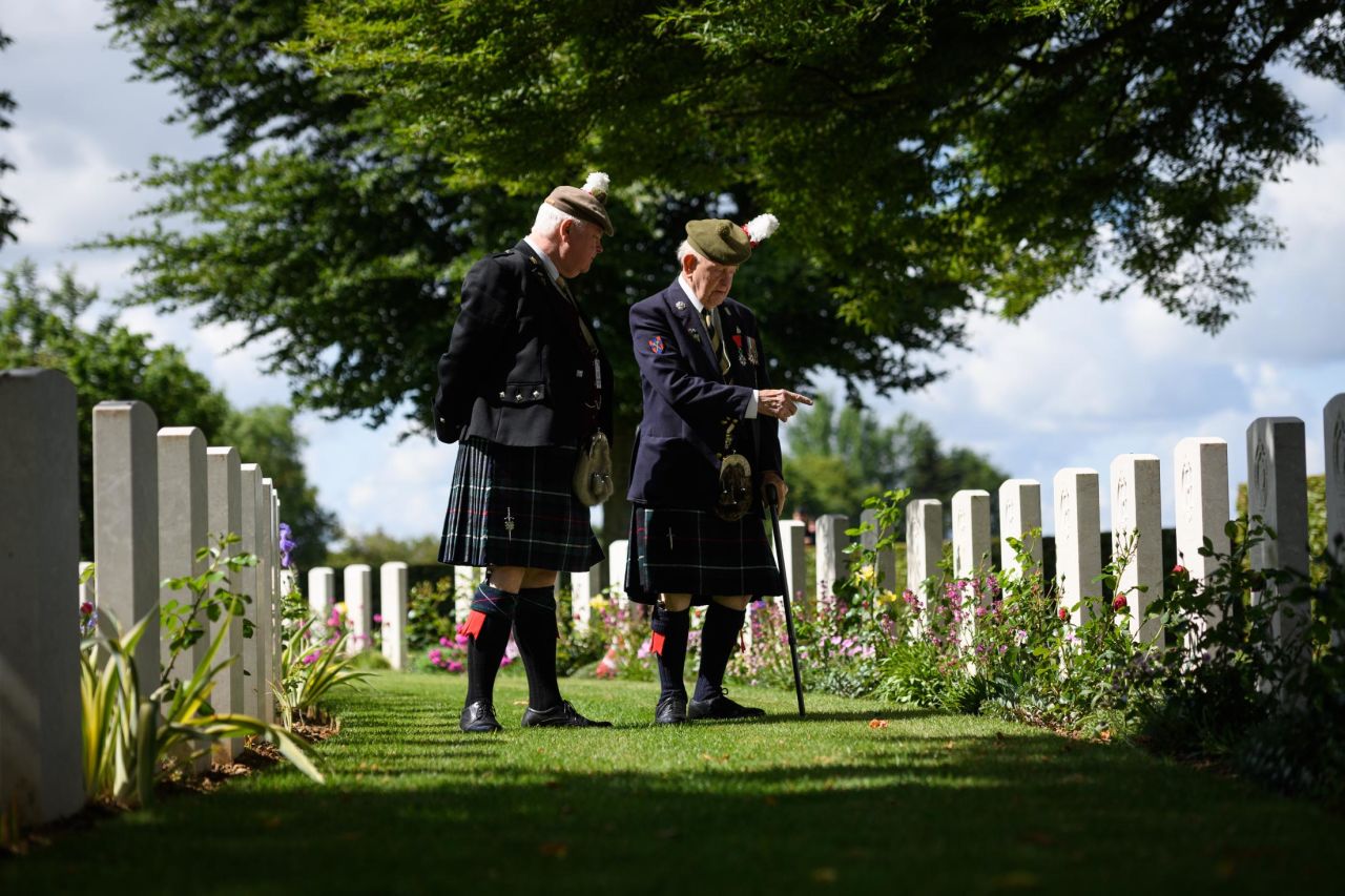 Veteran John Lamont (R) looks at some of the gravestones ahead of the memorial service in Bayeux Cemetery on Thursday in Bayeux, France. It has been announced that 16 countries had signed a historic proclamation of peace to ensure the horrors of the Second World War are never repeated. The text has been agreed upon by Australia, Belgium, Canada, Czech Republic, Denmark, France, Germany, Greece, Luxembourg, Netherlands, Norway, New Zealand, Poland, Slovakia, the United Kingdom and the United States of America.