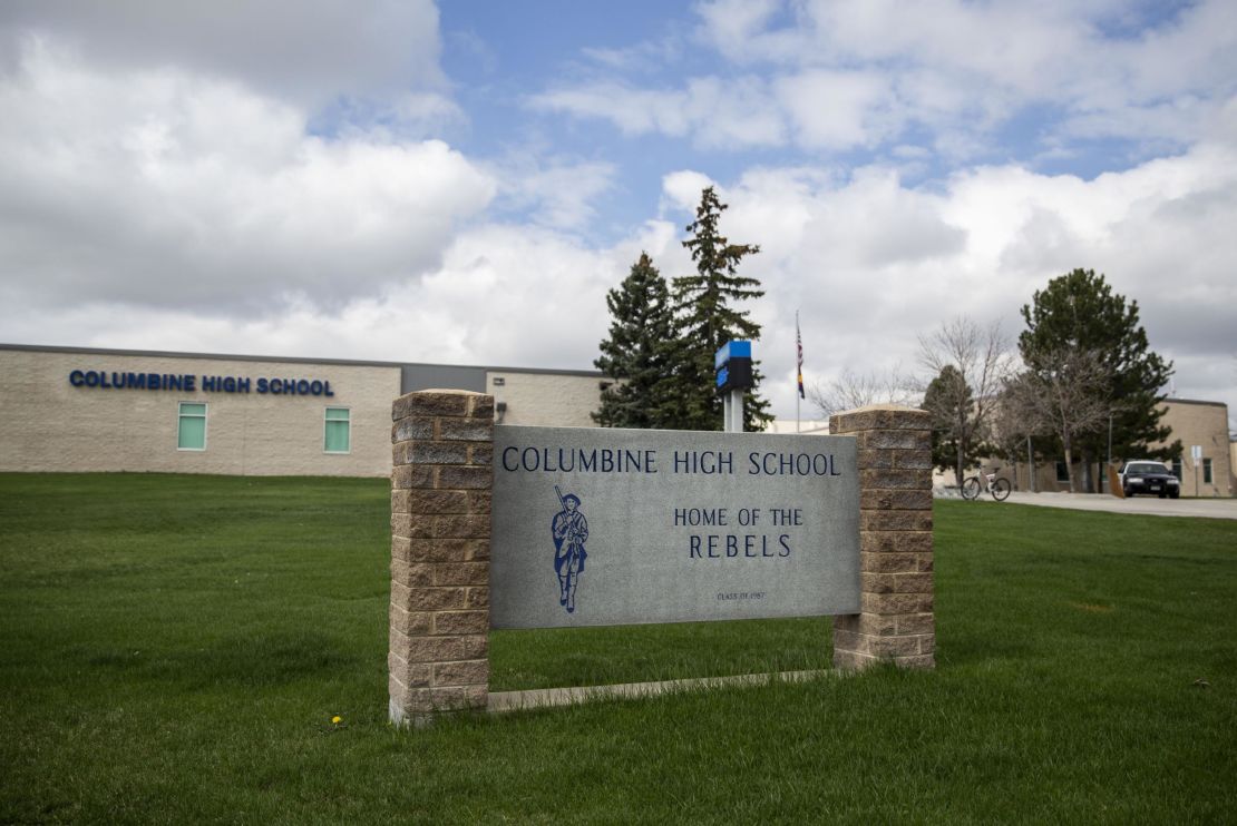 Police patrol outside Columbine High School in 2019, days before the 20th anniversary of a massacre at the school.