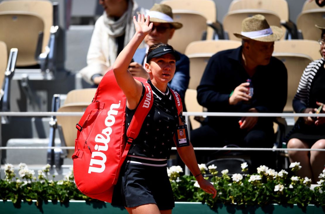 Simona Halep waves to the crowd after losing to Amanda Anisimova at the French Open. 