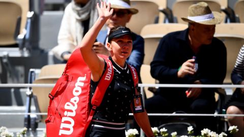 Simona Halep waves to the crowd after losing to Amanda Anisimova at the French Open. 