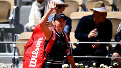 Simona Halep waves to the crowd after losing to Amanda Anisimova at the French Open.