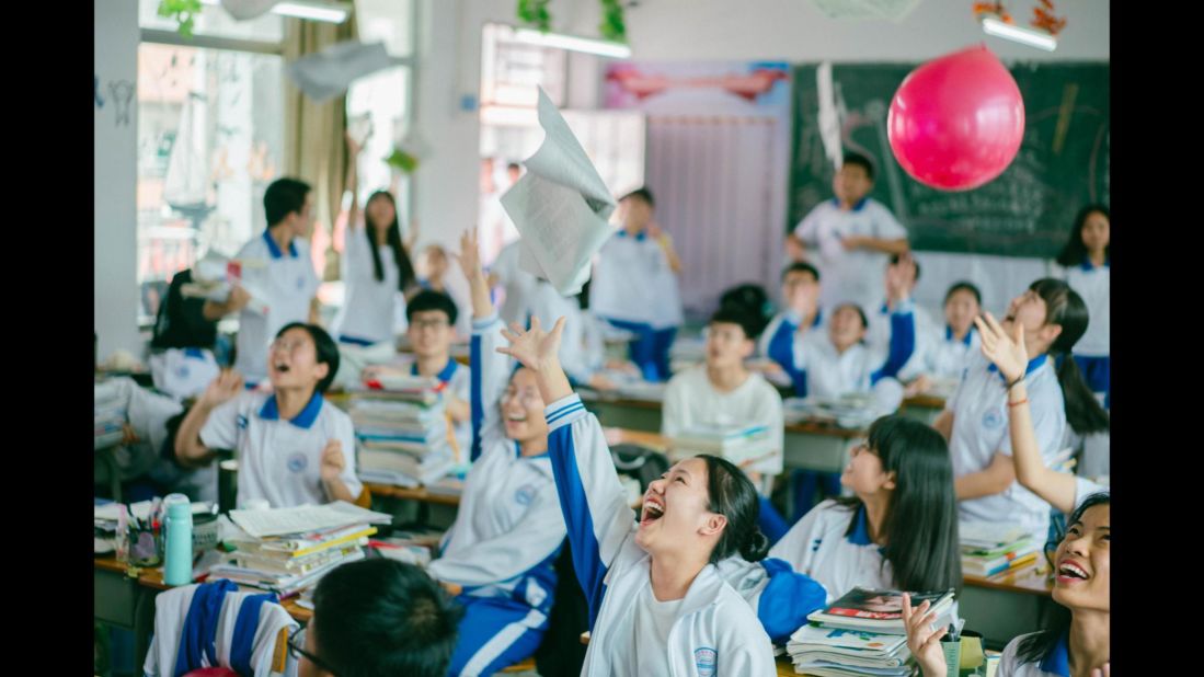 High school students in Huizhou, Guangdong province, throw books into the air on June 5, 2019, ahead of their college entrance exam on June 7. 