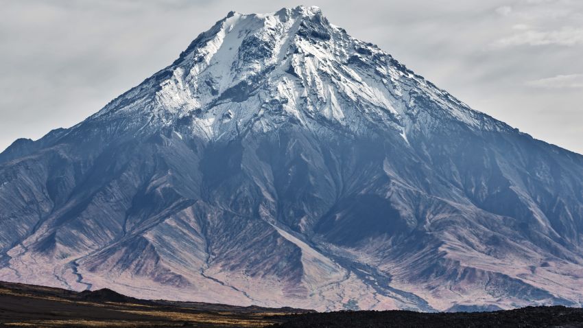Beautiful autumn volcanic landscape - view of snow-capped cone of stratovolcano Bolshaya Udina Volcano in Klyuchevskaya Group of Volcanoes. Russian Far East, Kamchatka Peninsula, Eurasia.; Shutterstock ID 753658408; Job: -