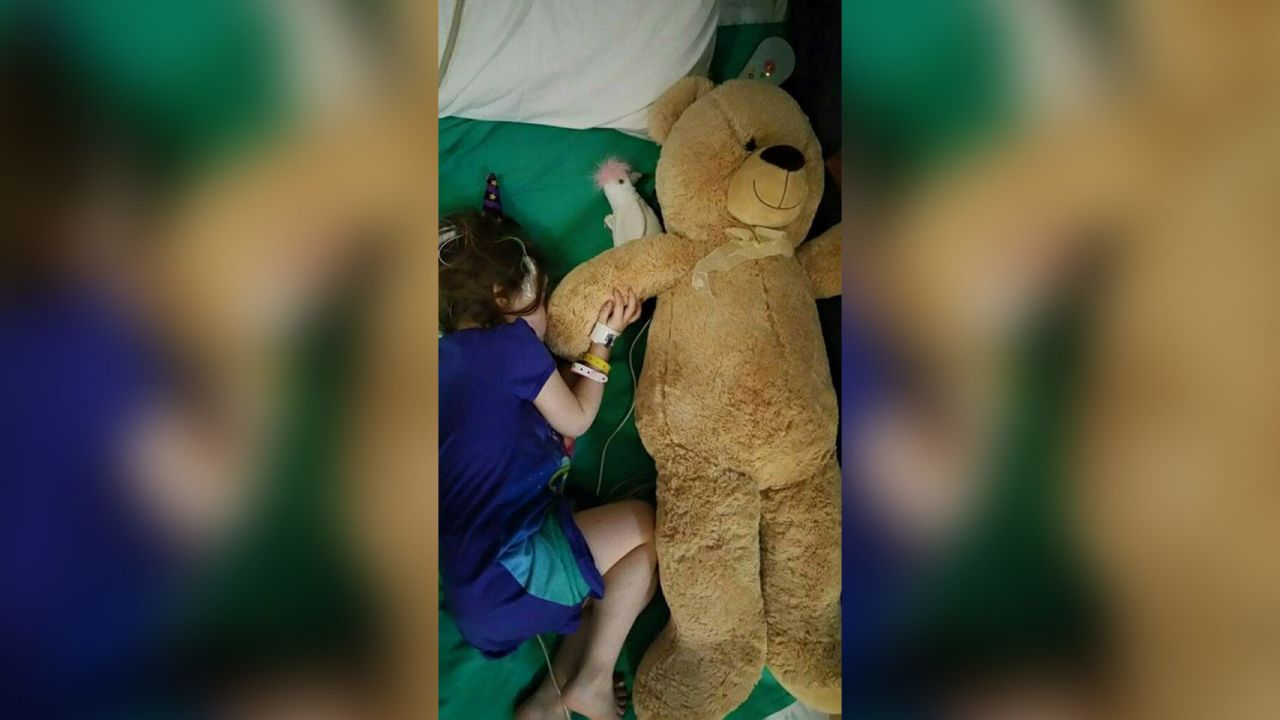 Alex Walker, 4, cuddles a teddy bear in the hospital. 