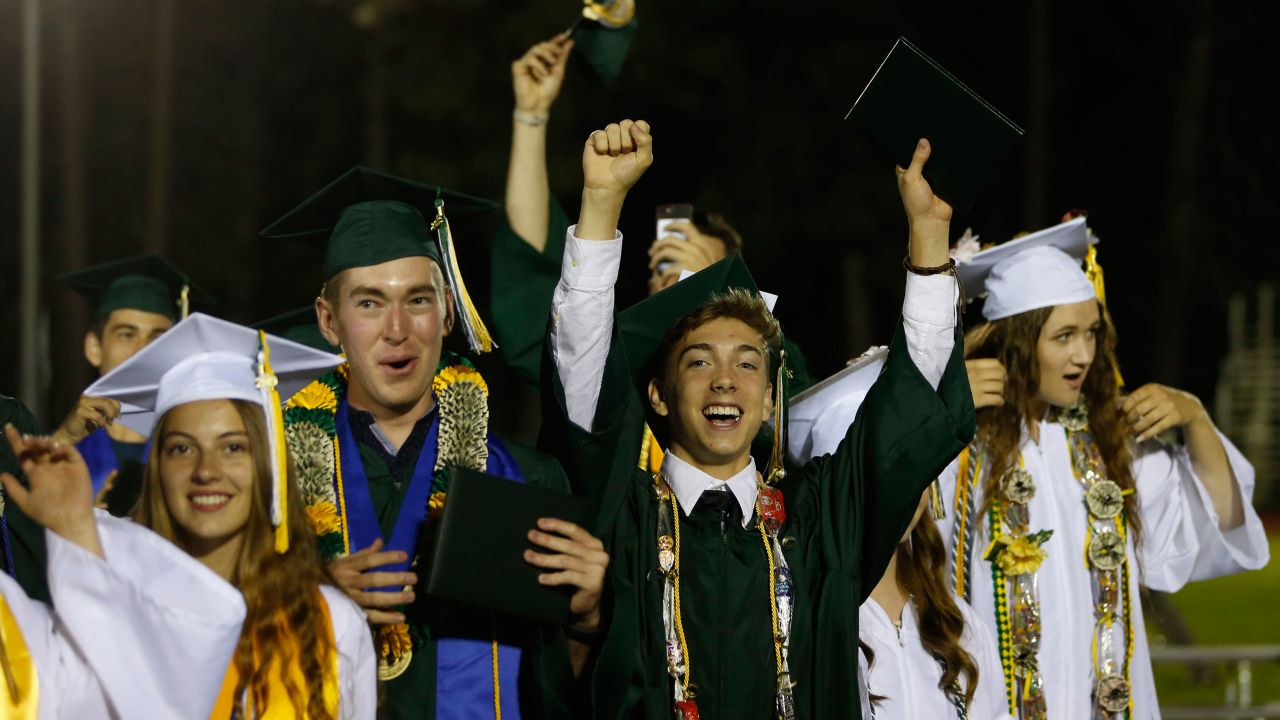Seniors celebrate at the end of their graduation ceremony for Paradise High School on Thursday night. 