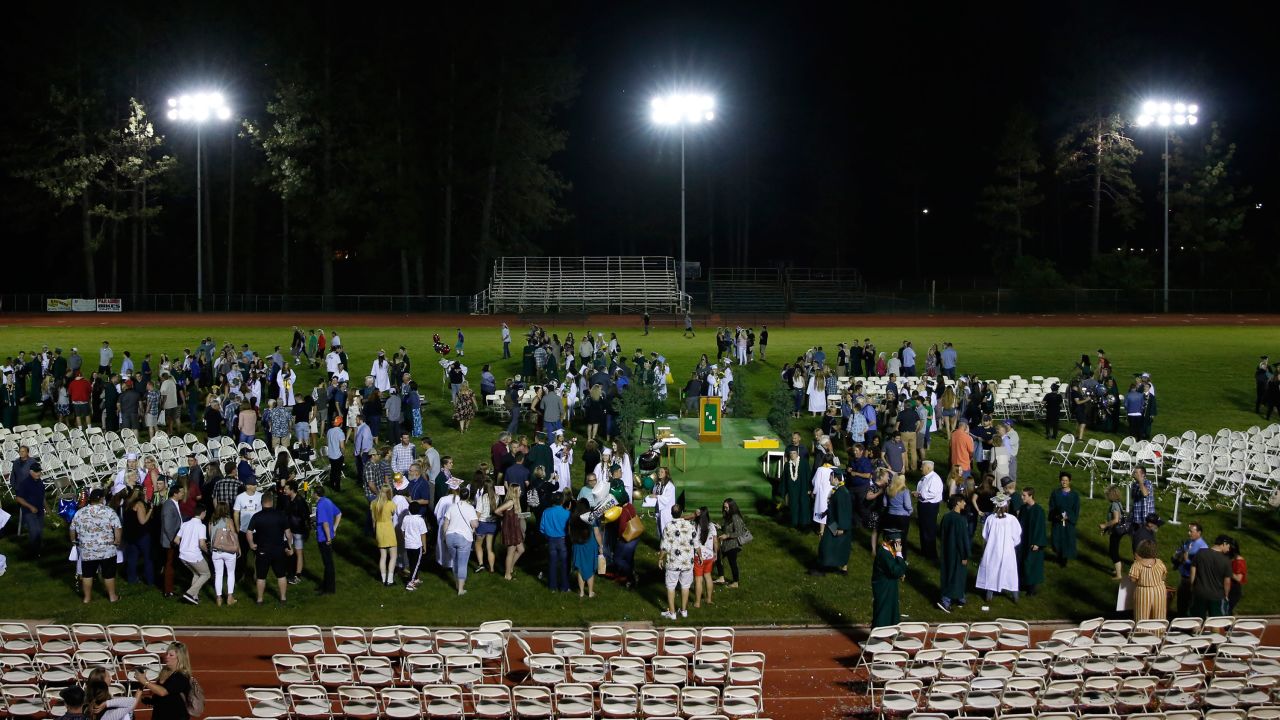 Newly graduated seniors gather with family and friends after the commencement ceremony at Paradise High School on Thursday.