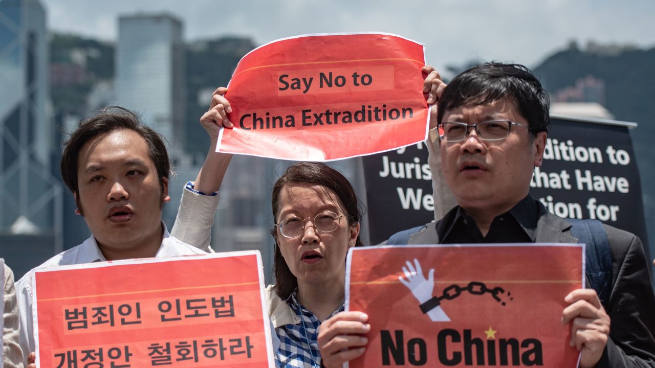 Members of the Anti-Extradition Bill Coalition hold placards opposing a proposed law which would allow for extradition between Hong Kong and mainland China in Hong Kong on June 2, 2019.