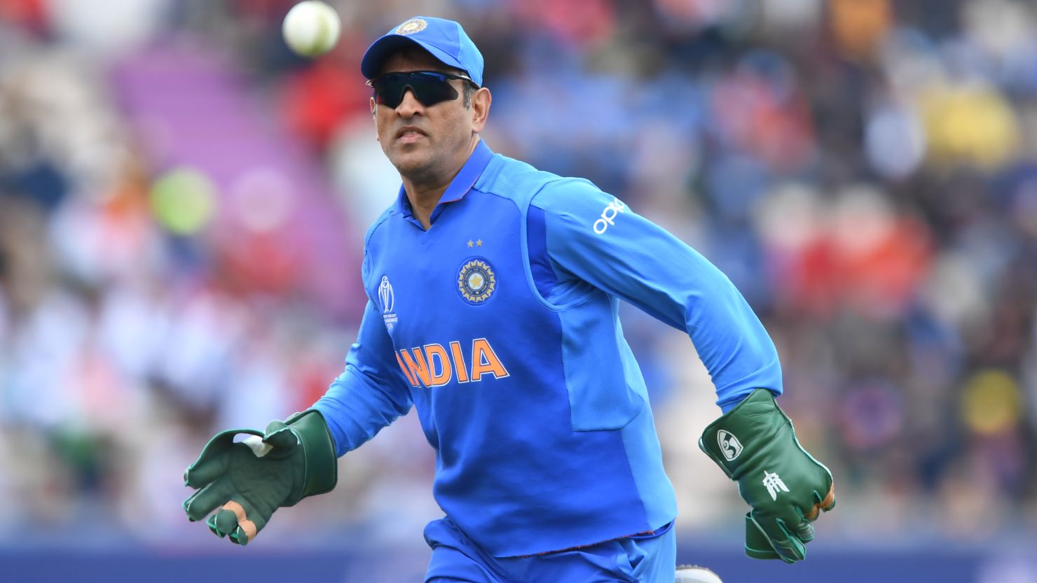 MS Dhoni wearing his wicketkeeping gloves with the army insignia.