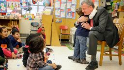 NEW YORK, NY - FEBRUARY 25:  New York City Mayor Bill de Blasio hugs a child after reading a book to a pre-kindergarten class at P.S. 130 on February 25, 2014 in New York City. De Blasio stopped by the classroom after a news conference about his plans for universal pre-kindergarten in New York City. (Photo by Seth Wenig-Pool/Getty Images)