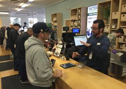 A "budtender" assists a customer inside Harborside's Oakland dispensary. 