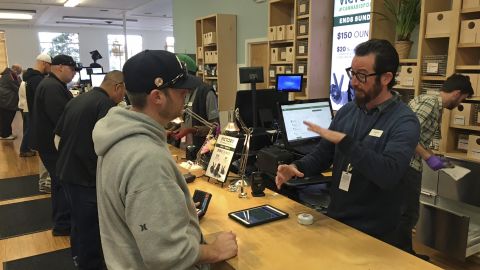 A "budtender" assists a customer inside Harborside's Oakland dispensary. 