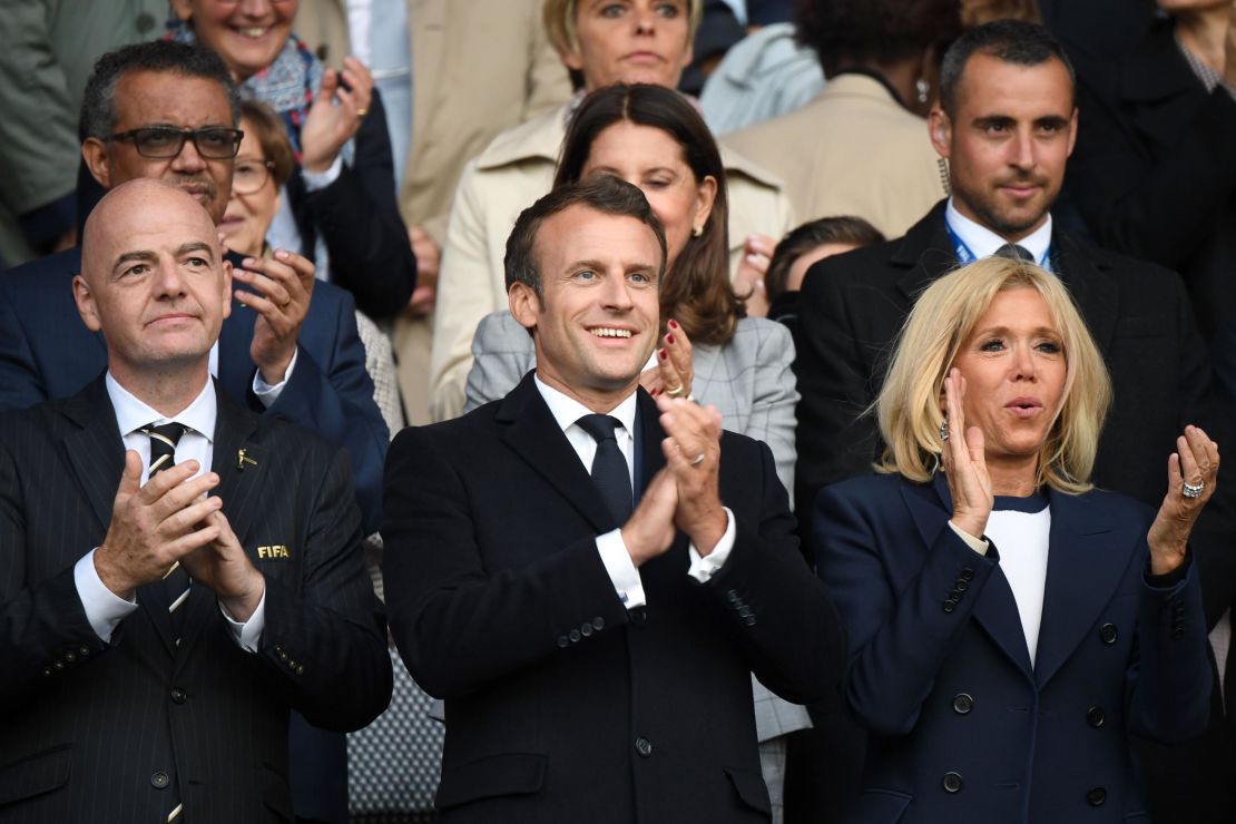 French President Emmanuel Macron and French first lady Brigitte Macron applaud ahead of the start of the Women's World Cup.
