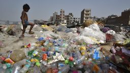 NEW DELHI, INDIA - JUNE 4:  A boy looks for recyclable material as piles of plastic lie on the bank of Yamuna on a hot summer day, near Okhla on June 4, 2019 in New Delhi, India.  World Environment Day is marked anually on June 5. (Photo by Biplov Bhuyan/Hindustan Times via Getty Images)