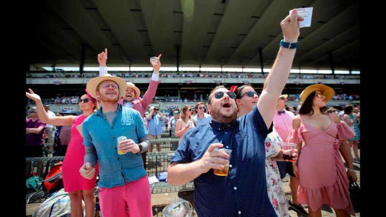 Spectators cheer during one of the early races before the 151st running of the Belmont Stakes.