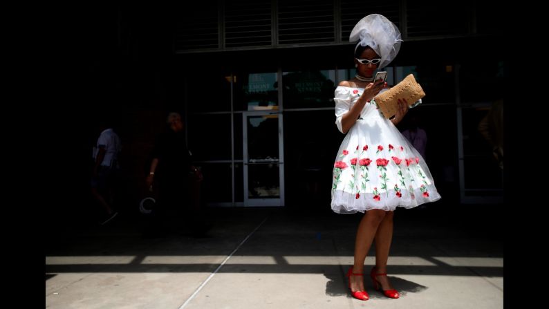 Mekeda Grant, of Brooklyn, checks her phone while walking through the grandstand.