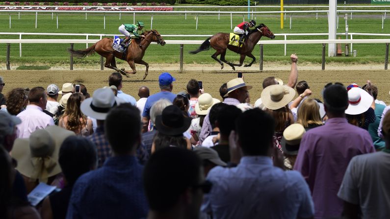 From left, Pacific Wind and Escape Clause approach the finish line during the fifth race of the day before the 151st running of the Belmont Stakes.
