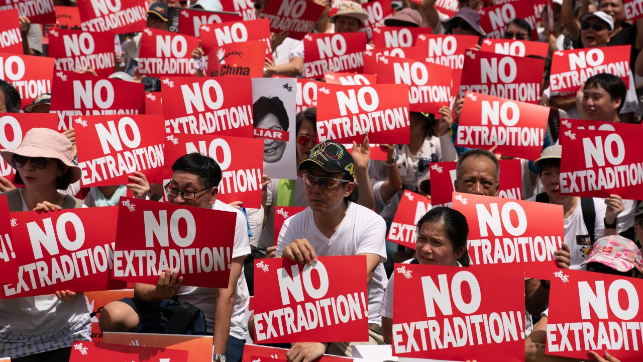 HONG KONG, HONG KONG - JUNE 09:  Protesters hold placards and shout slogans during a rally against the extradition law proposal on June 9, 2019 in Hong Kong China. Hundreds of thousands of protesters marched in Hong Kong in Sunday against a controversial extradition bill that would allow suspected criminals to be sent to mainland China for trial.(Photo by Anthony Kwan/Getty Images)