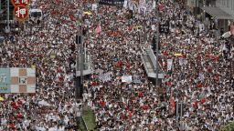 Tens of thousands of protesters march along a downtown street against the proposed amendments to an extradition law in Hong Kong Sunday, June 9, 2019. The amendments have been widely criticized as eroding the semi-autonomous Chinese territory's judicial independence by making it easier to send criminal suspects to mainland China, where they could face vague national security charges and unfair trials. (AP Photo/Vincent Yu)