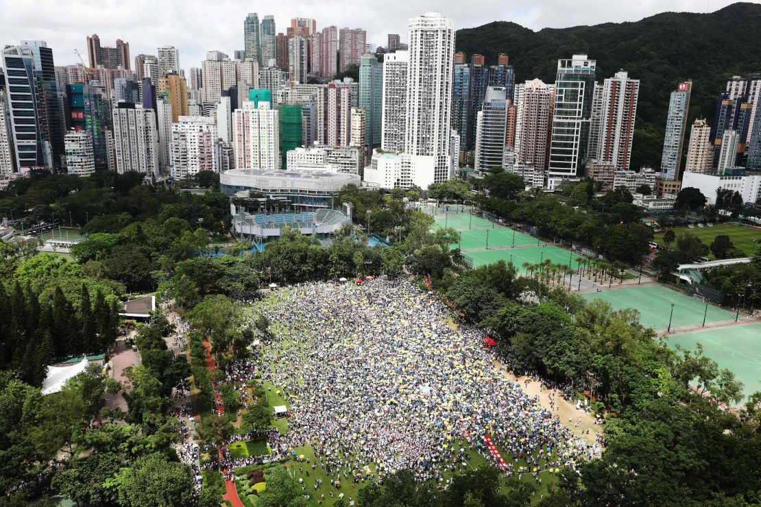 Protesters waved placards and wore white -- the designated color of the rally. "Hong Kong, never give up!" some chanted.