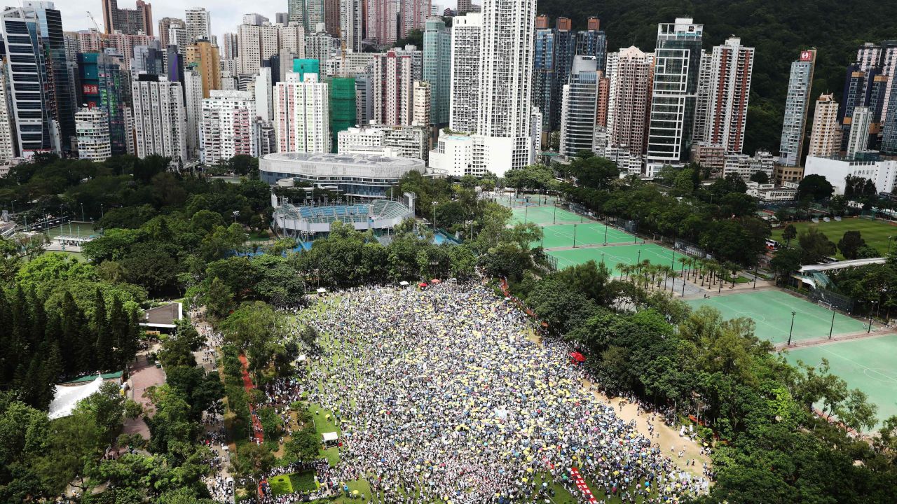Protesters waved placards and wore white -- the designated color of the rally. "Hong Kong, never give up!" some chanted.