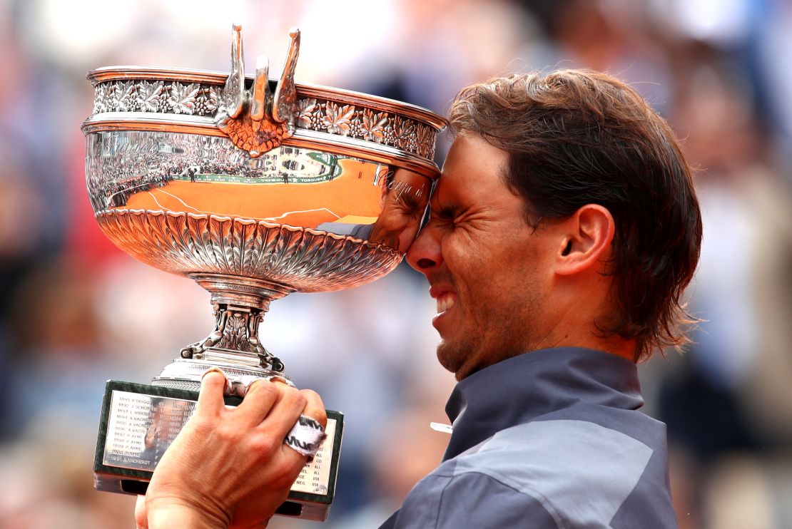 Rafael Nadal lifts the French Open trophy for the 12th time after his four-set victory over Dominic Thiem in Paris.